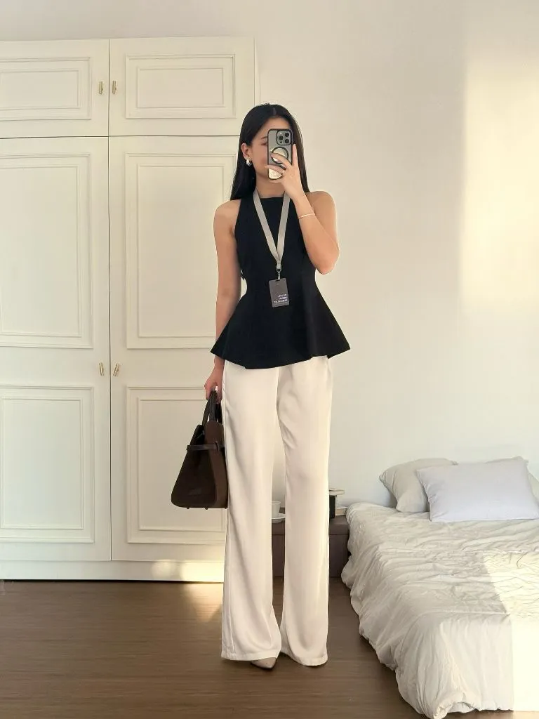 Black peplum halter top with cream wide-leg trousers and brown bag, mirror selfie