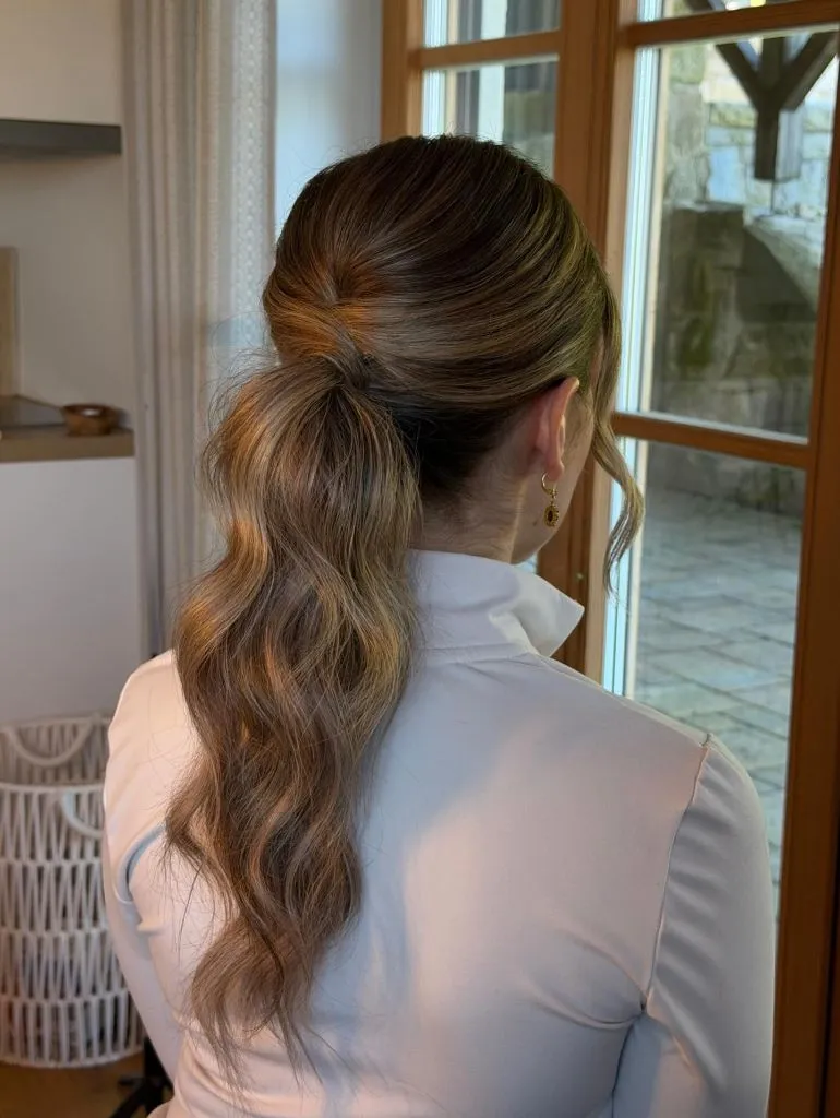 Fall Hairstyles for Wedding Guests 2026 Elegant Wrapped Ponytail with Soft Waves