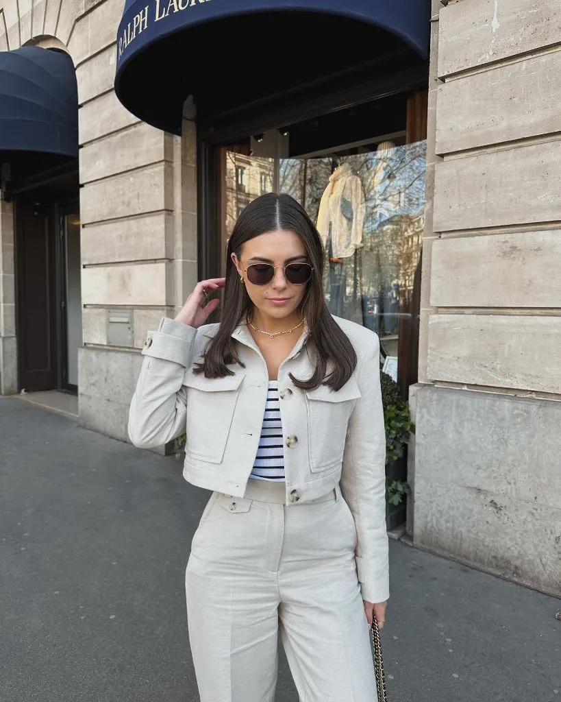 Cream cropped jacket with Breton stripe top in front of Ralph Lauren store