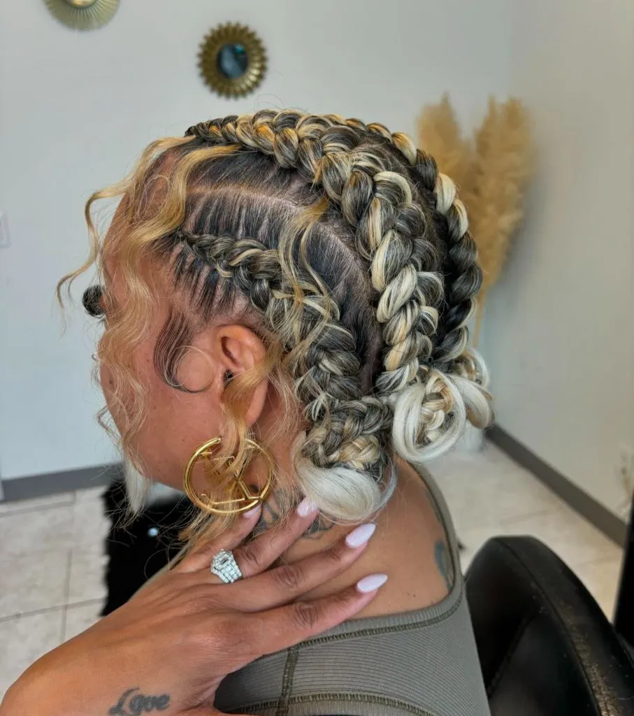 Butterfly Braids Hairstyle Blonde-Highlighted Stitch Braids Gathered into a Low Braided Bun