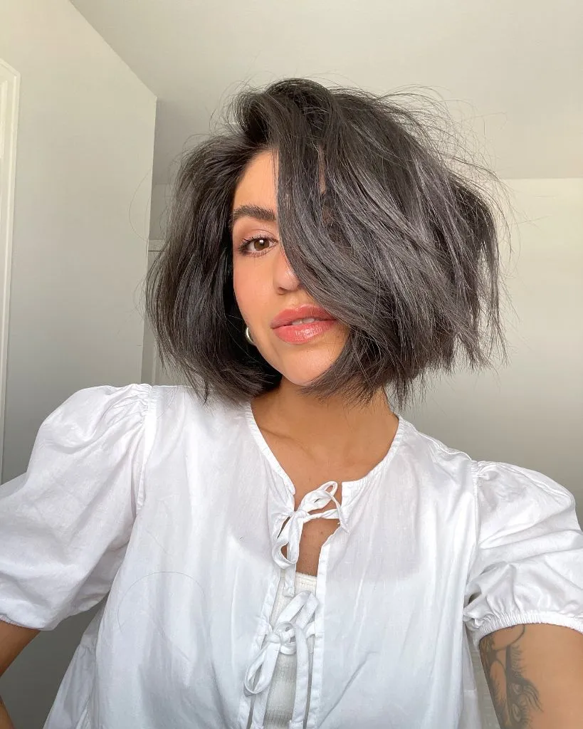 Bobbed Haircut for Women Tousled Dark Brunette Volume Bob with Deep Side Part