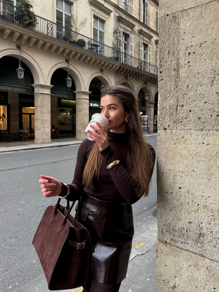 Dark brown turtleneck with chocolate leather skirt and matching suede bag in Paris