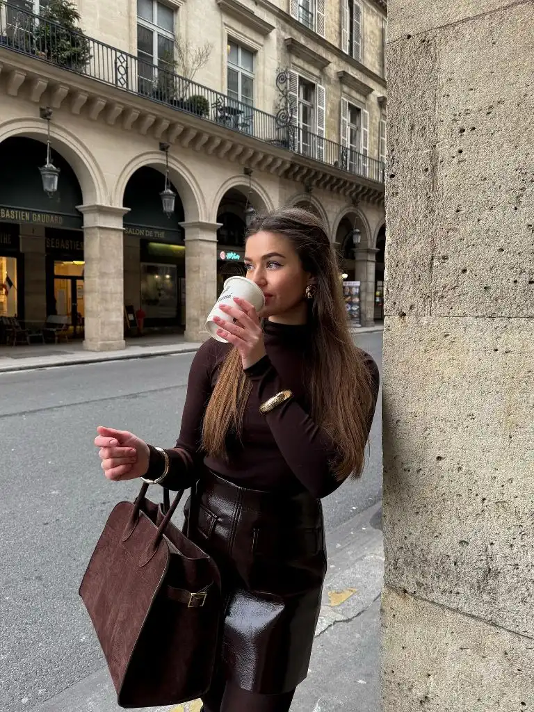 Dark brown turtleneck with chocolate leather skirt and matching suede bag in Paris