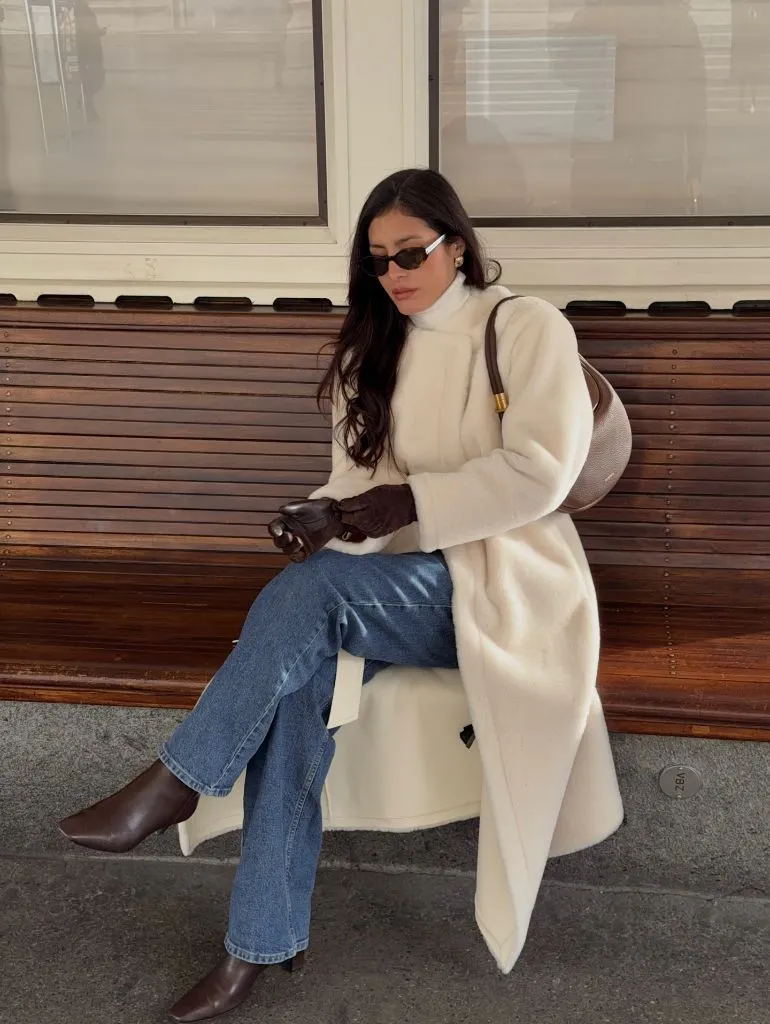 Long cream coat with jeans and chocolate brown boots