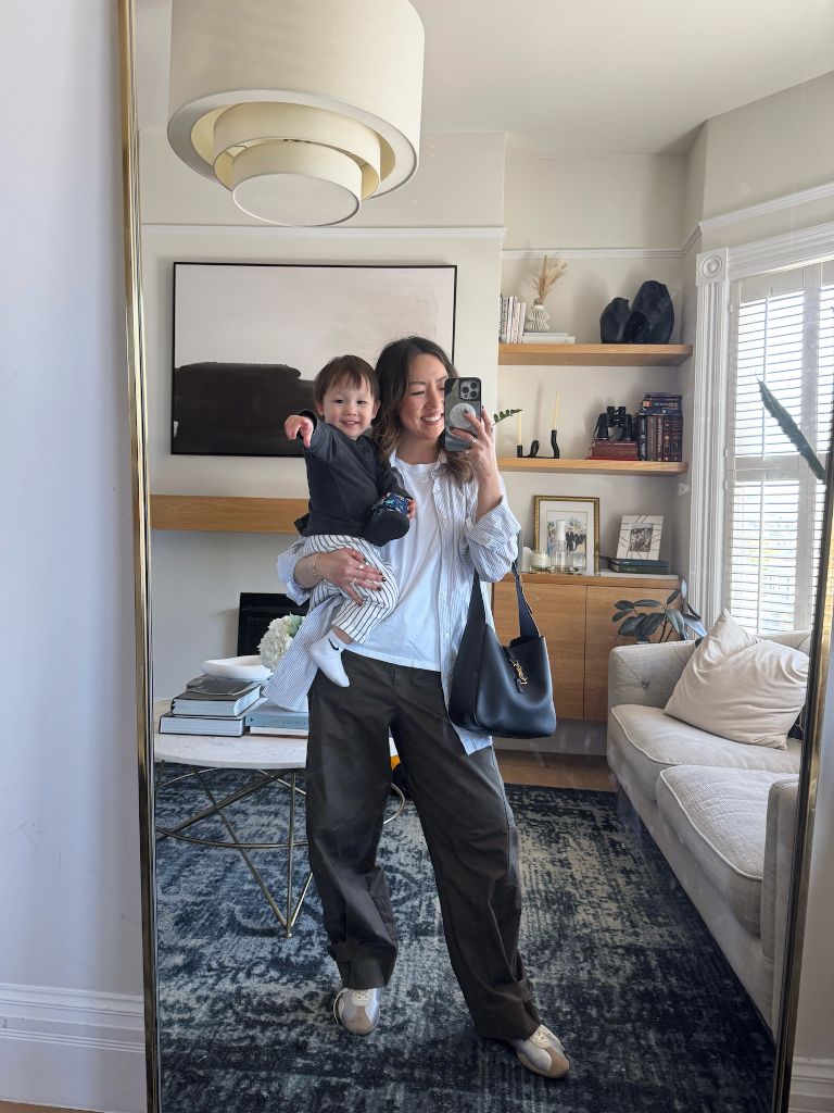 Mirror selfie with child in button-down shirt and olive trousers