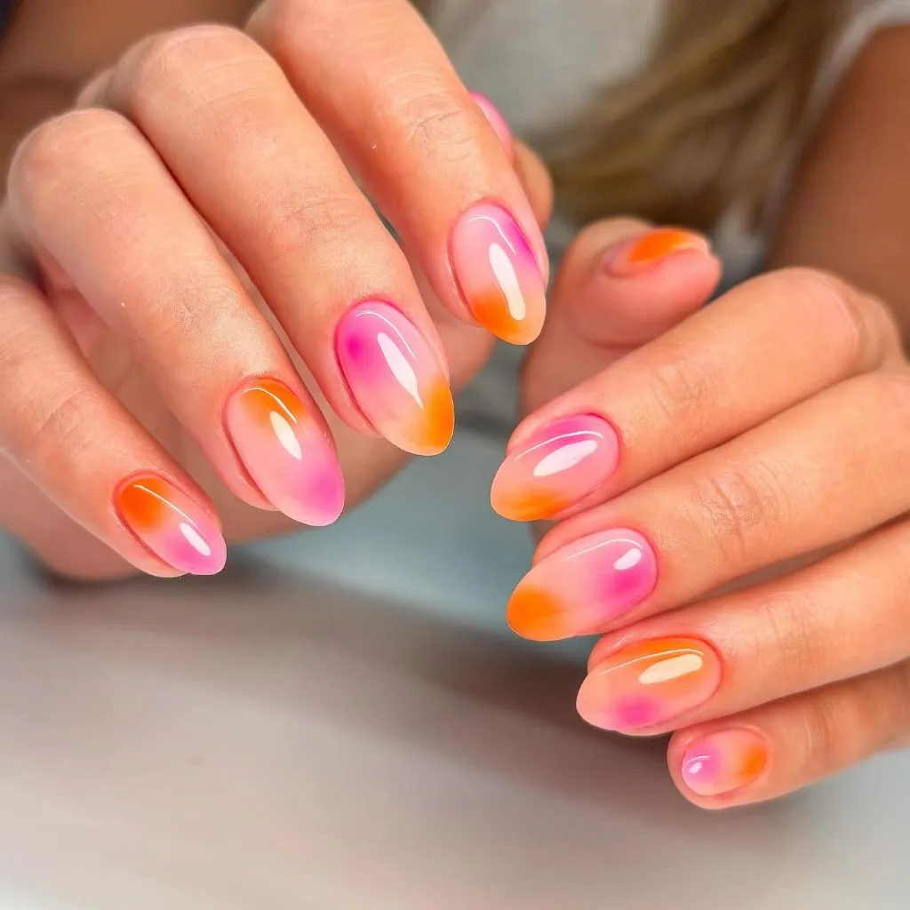 Pink and orange sunset aura ombre nails on almond nails August nails color 2026 ideas