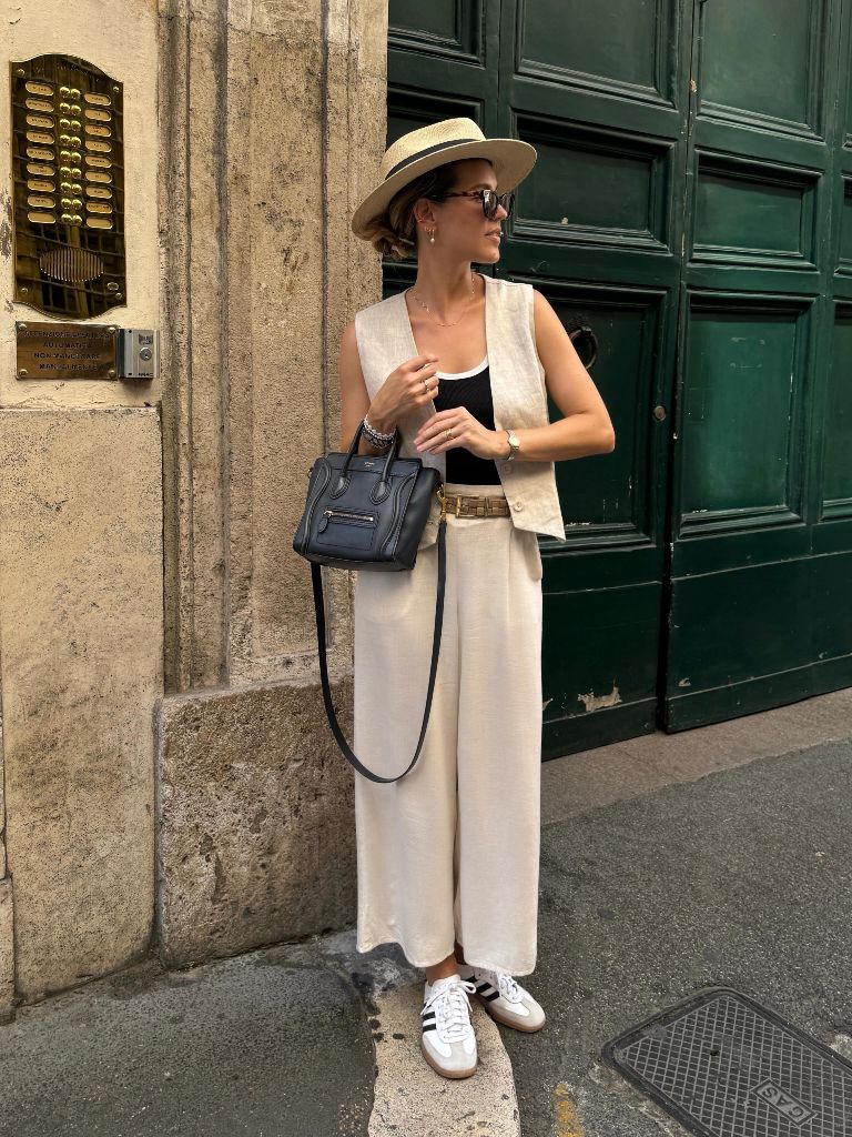 Cream linen vest and wide-leg pants with straw hat and Céline bag