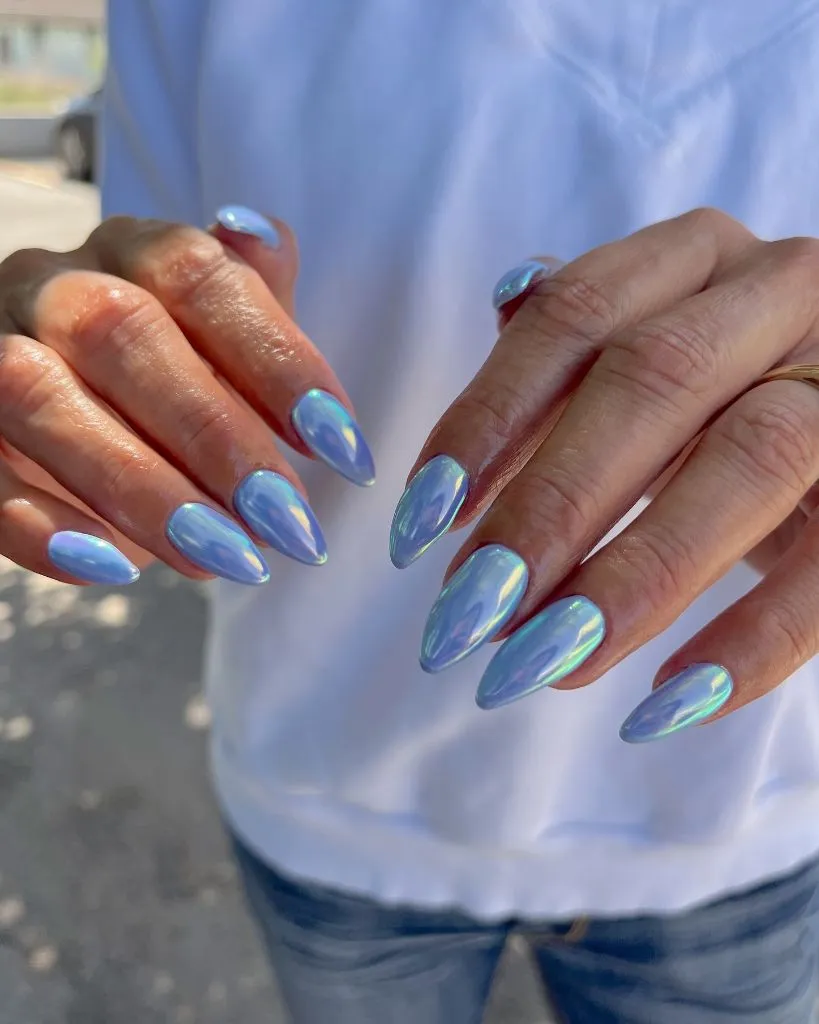 Holographic periwinkle chrome almond nails, iridescent August nail trend 2026