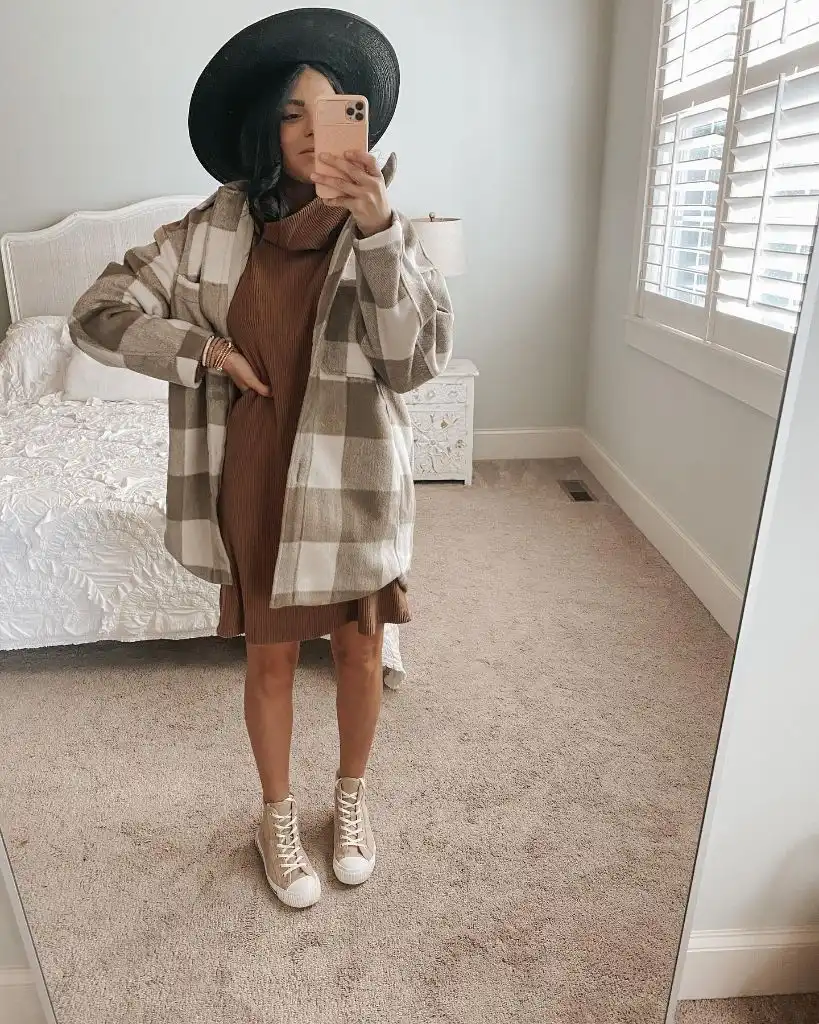Mirror selfie in checked shacket over brown sweater dress