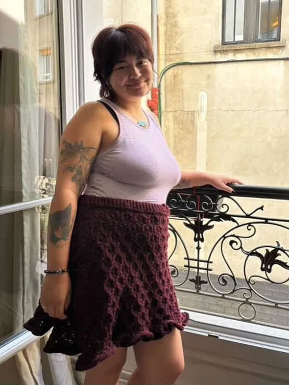 Burgundy honeycomb-knit mini skirt with lilac tank top on a Paris balcony
