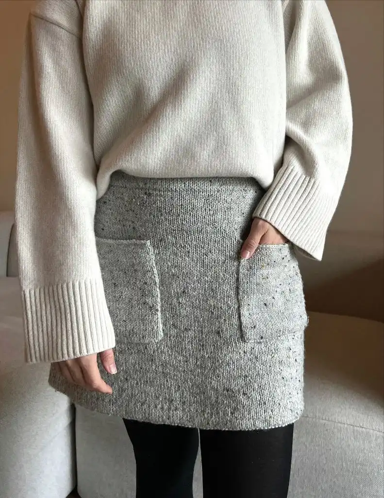 Grey speckled knit mini skirt with patch pockets and cream sweater