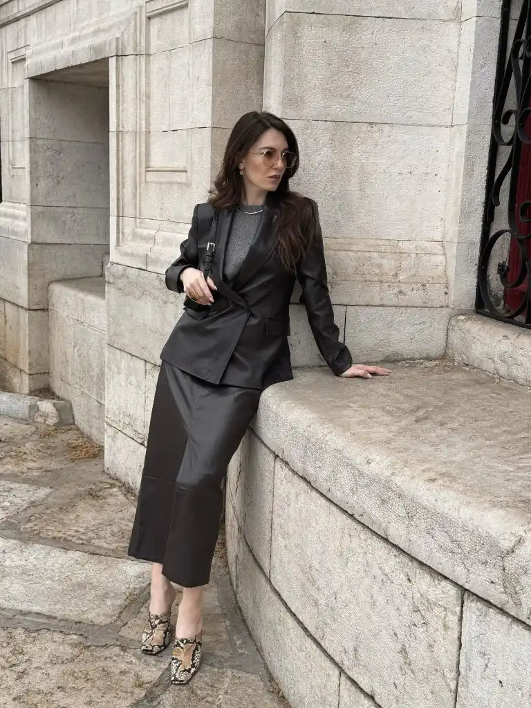 Dark leather blazer and midi skirt with snakeskin mules