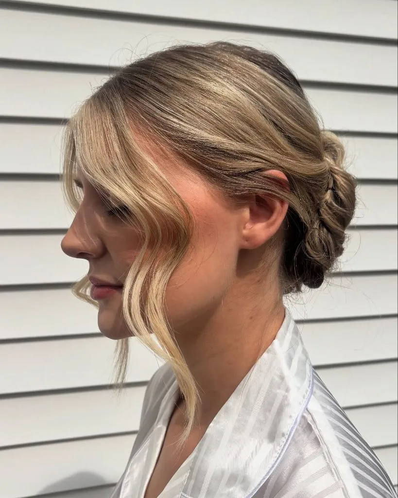 Fall Hairstyles for Wedding Guests 2026 Relaxed Low Bun with Curtain-Framed Face