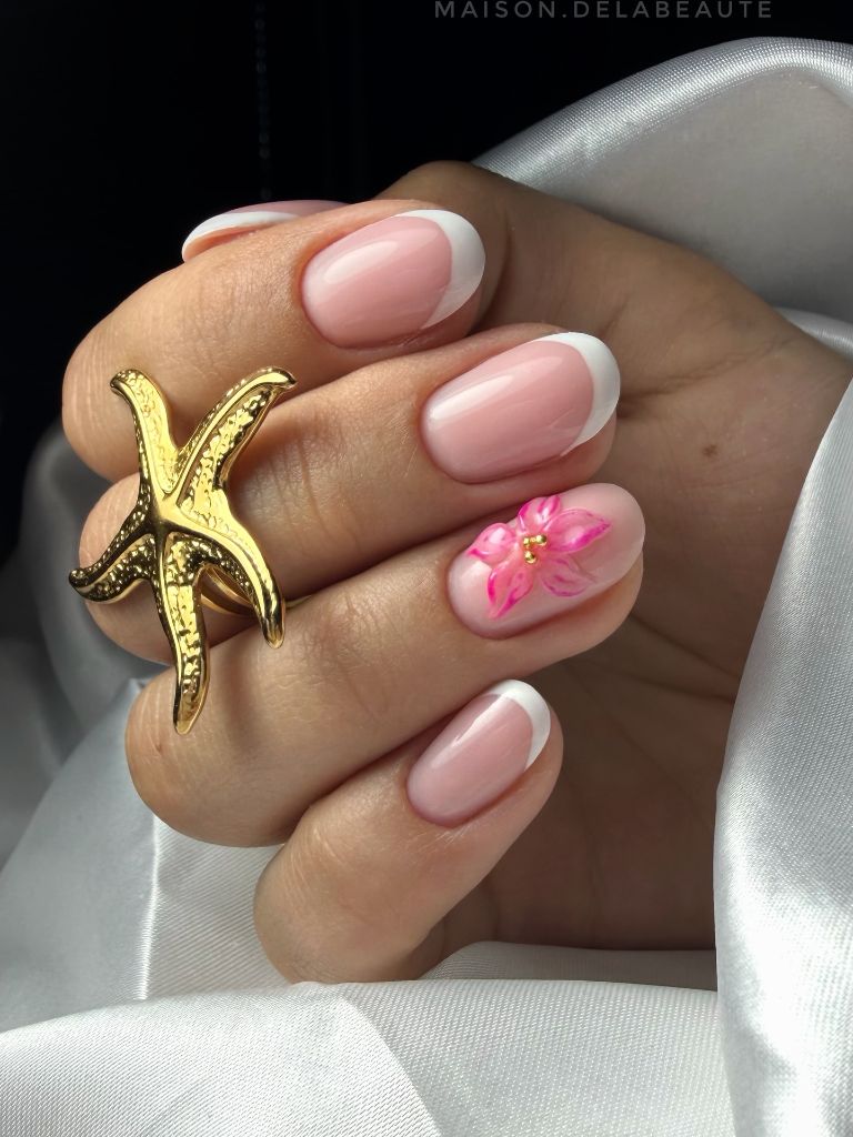 Classic French tip nails with 3D pink flower accent, elegant August nails 2026