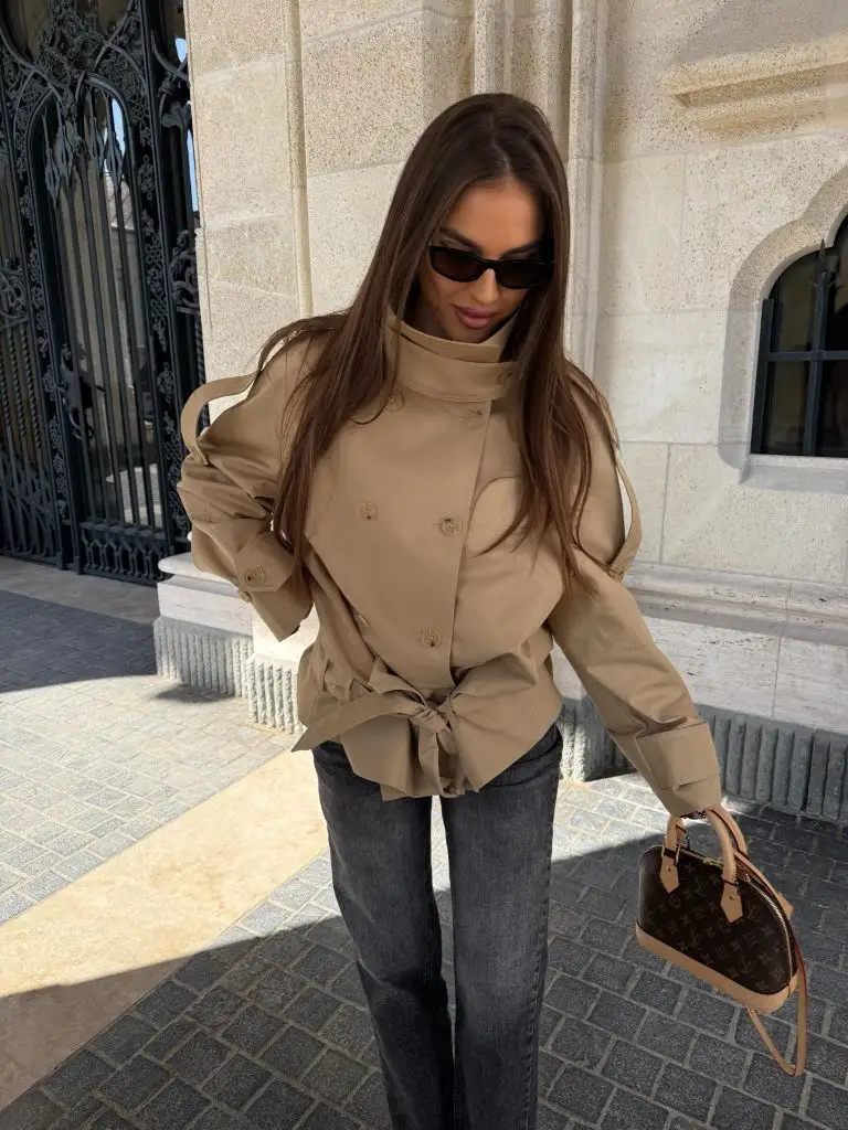 Beige double-breasted cropped peacoat with grey jeans and Louis Vuitton bag