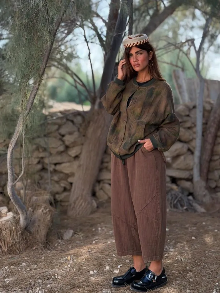 Olive tie-dye bomber with brown wide-leg pants and platform loafers