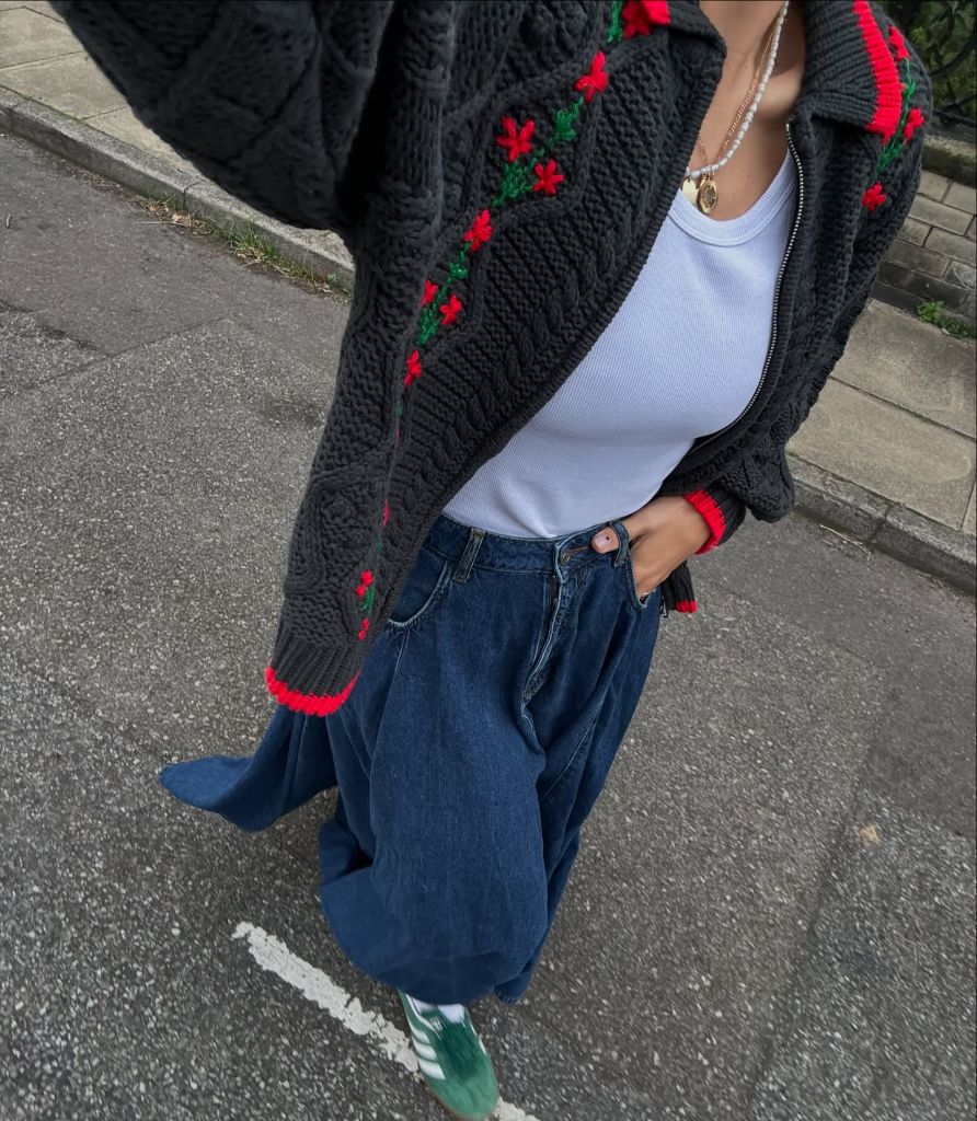 Fall professional outfit black embroidered knit cardigan white tank baggy jeans green sneakers