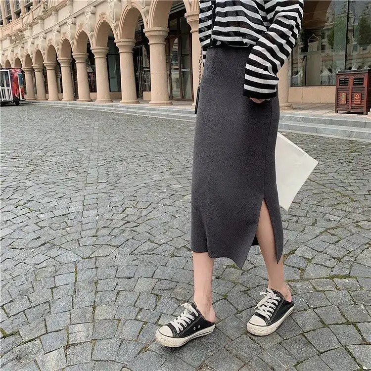 Dark grey knit midi skirt with side slit and black-and-white striped sweater