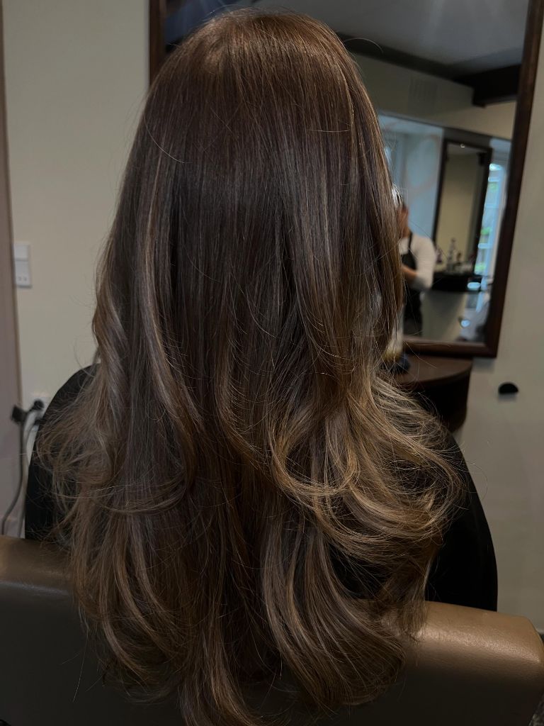 Fall Haircuts for Women 2026 Glossy Chocolate Balayage with Soft Curled Ends