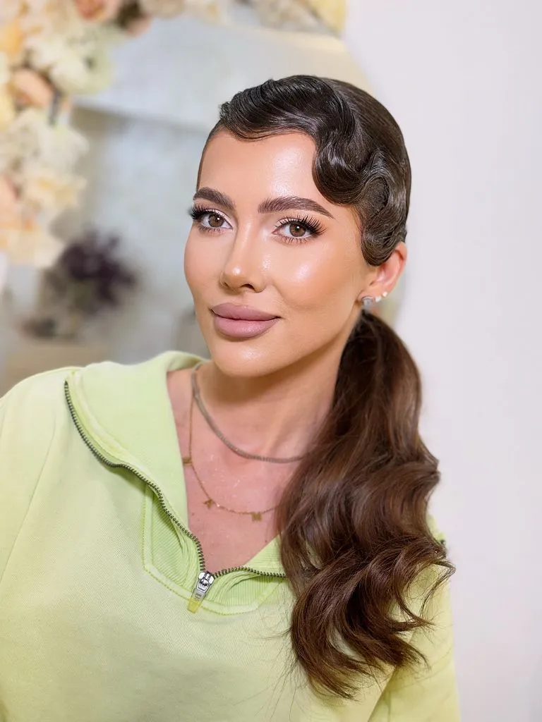 Fall Hairstyles for Wedding Guests 2026 Sculpted Finger Waves with Low Ponytail