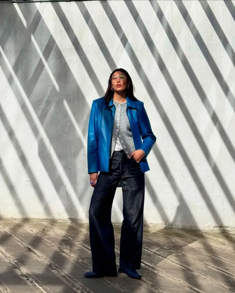 Fall professional outfit blue leather jacket grey henley wide leg denim
