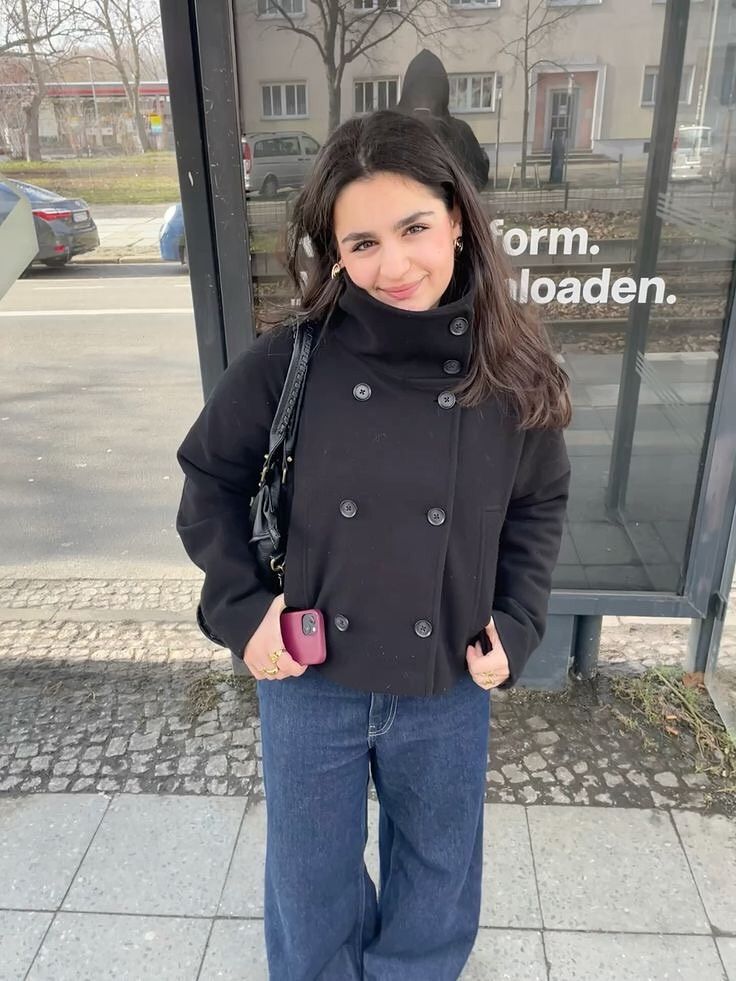 Black double-breasted funnel neck peacoat with blue jeans