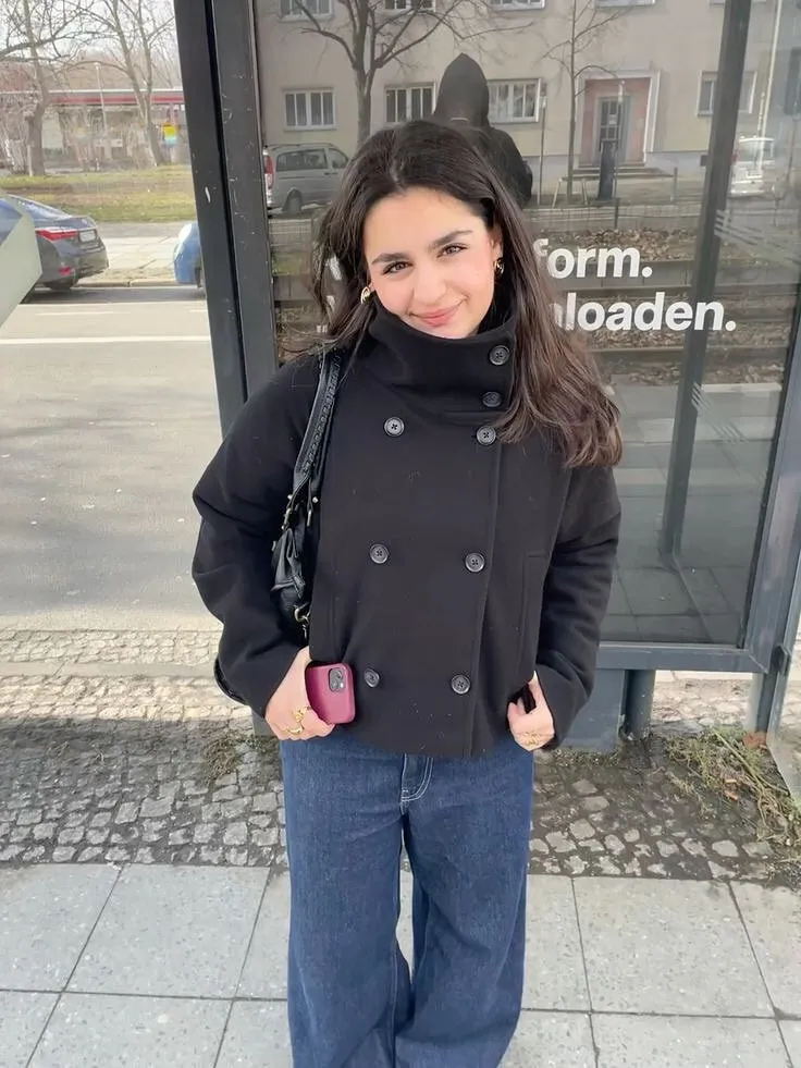 Black double-breasted funnel neck peacoat with blue jeans