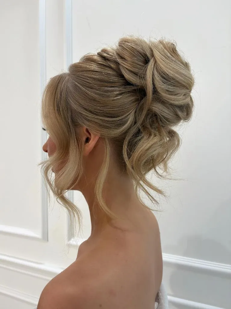 Fall Hairstyles for Office 2026 Romantic Loose High Bun with Cascading Tendrils