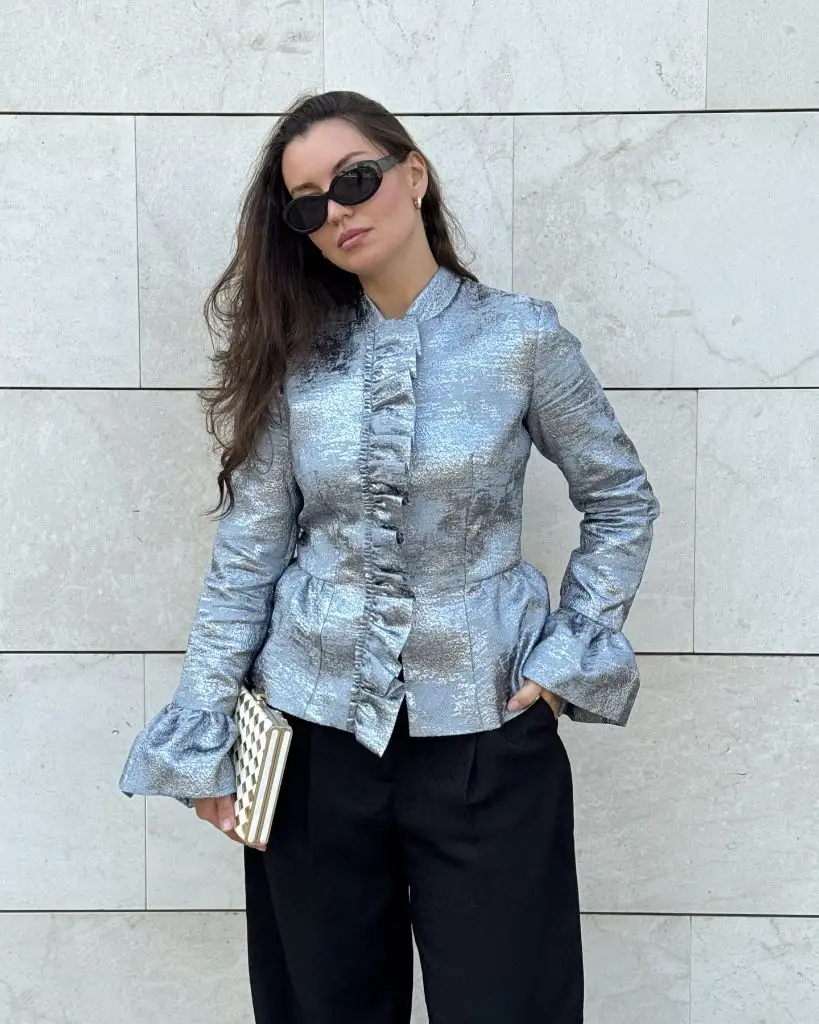Silver brocade ruffle jacket with black trousers