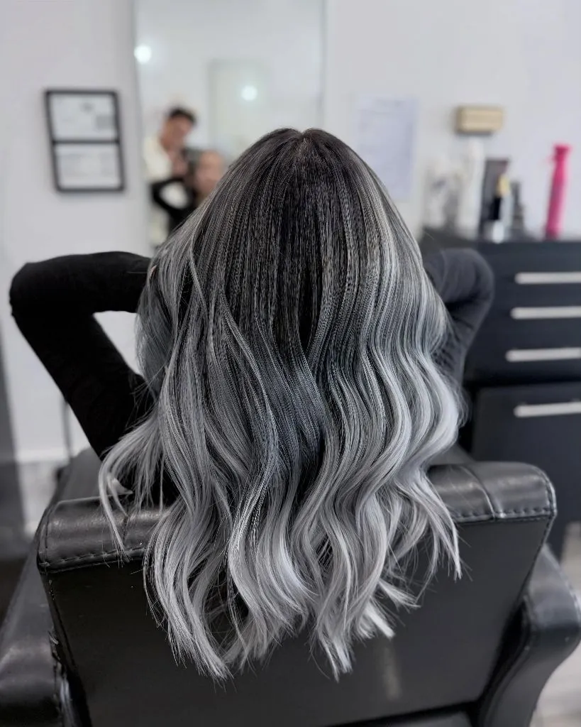 Dark root melting into silver gray waves from the back
