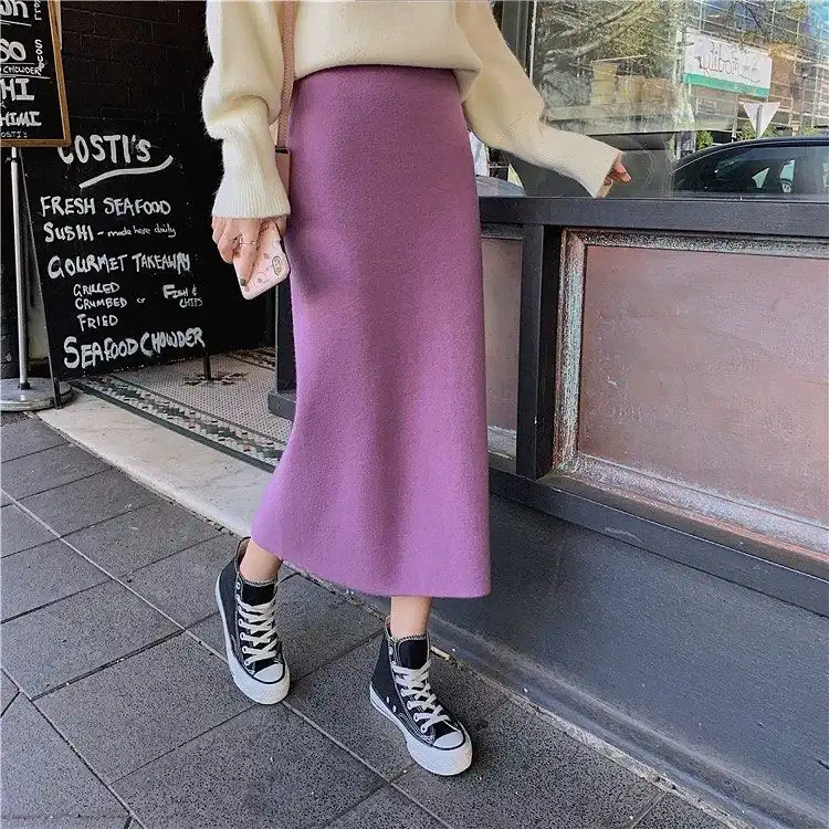 Purple knit midi skirt with cream oversized sweater and black Converse