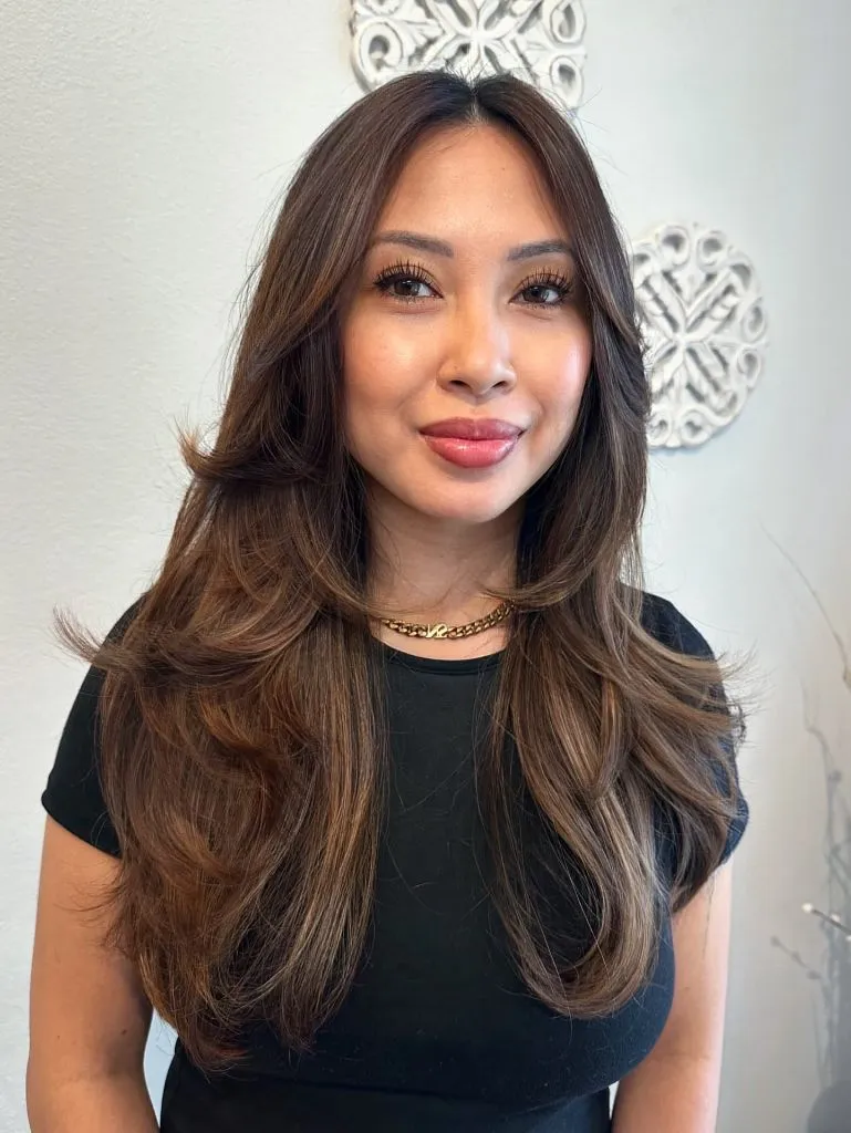 Fall Medium Haircuts 2026 Warm Brunette Butterfly Layers with a Polished Blowout