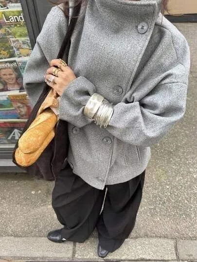 Grey wool peacoat close-up with silver bangles and baguette