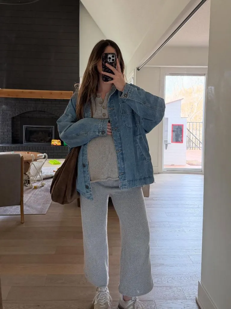 Mirror selfie in oversized denim jacket over knit set