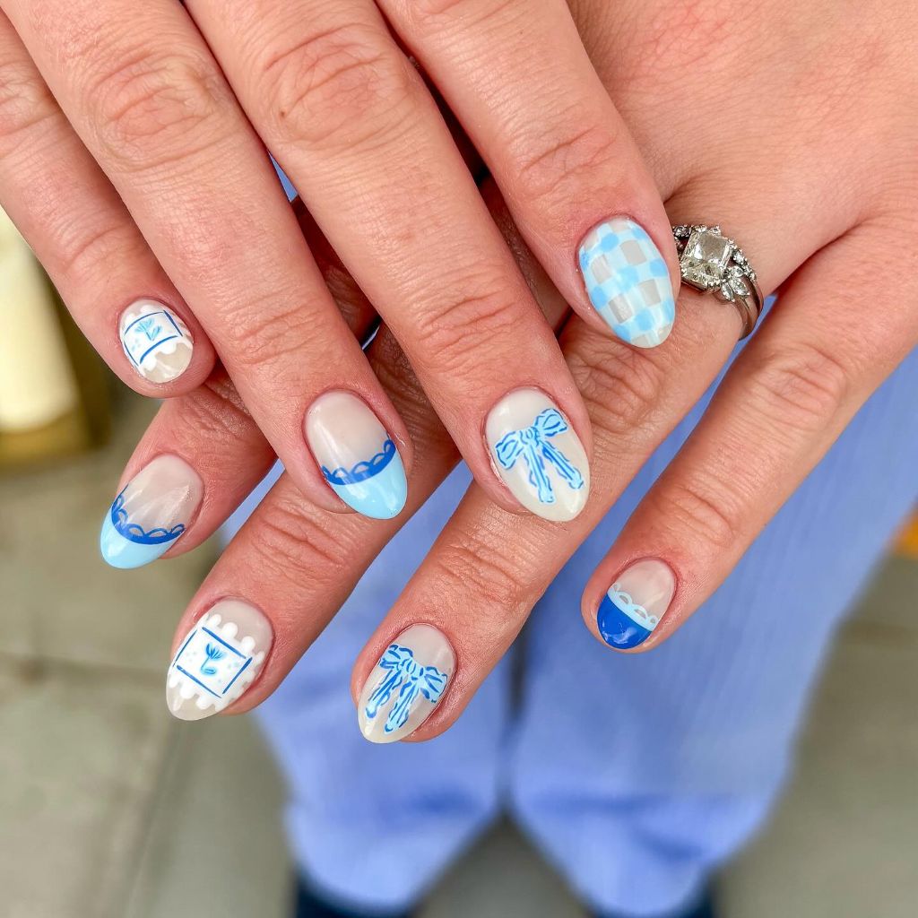Blue and white coquette nail art with bows checkerboard and lace details on almond nails August nails color 2026 ideas