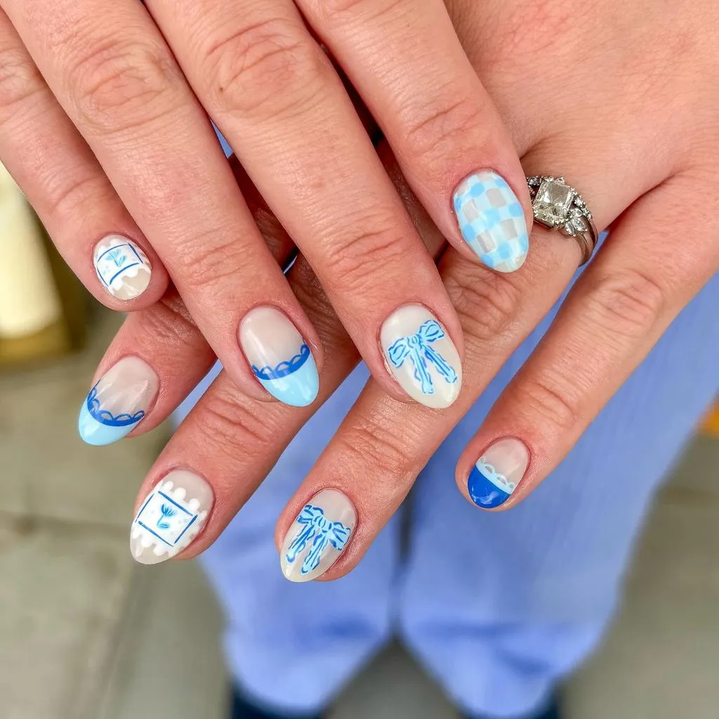 Blue and white coquette nail art with bows checkerboard and lace details on almond nails August nails color 2026 ideas