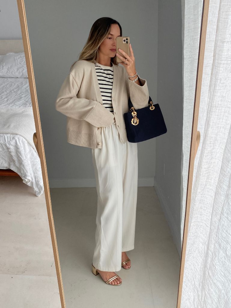 Mirror selfie with cream cardigan, striped top, white trousers, and Dior bag