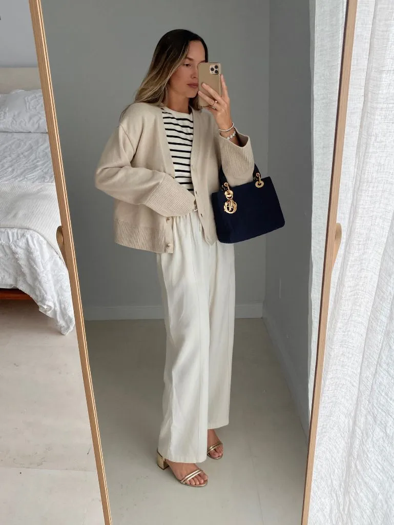 Mirror selfie with cream cardigan, striped top, white trousers, and Dior bag