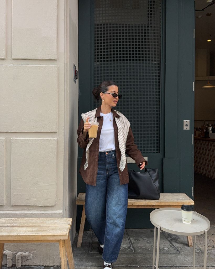 Brown suede jacket and jeans at café