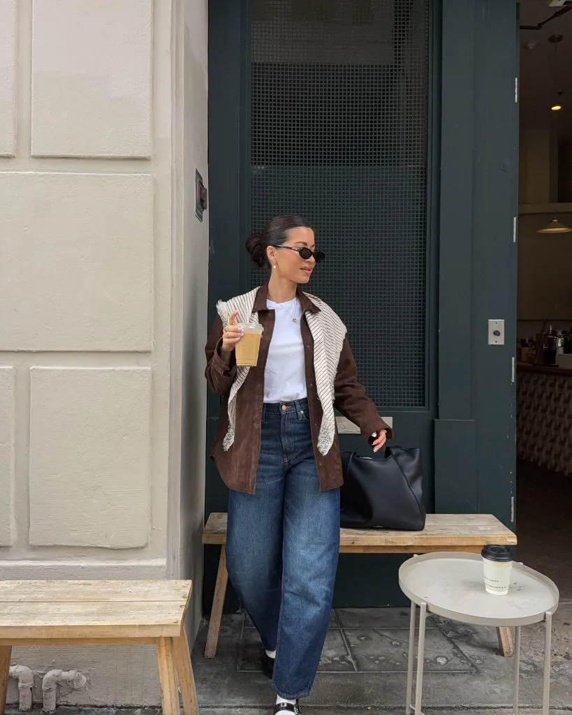 Brown suede jacket and jeans at café