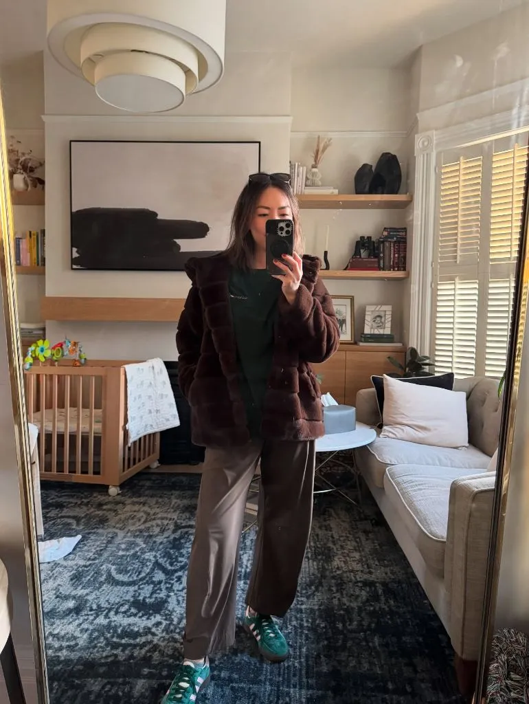 Mirror selfie in dark brown faux fur jacket with green Adidas sneakers