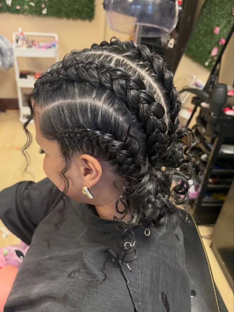 Butterfly Braids Hairstyle Multiple Cornrows into a Curly Low Bun with Detailed Partings
