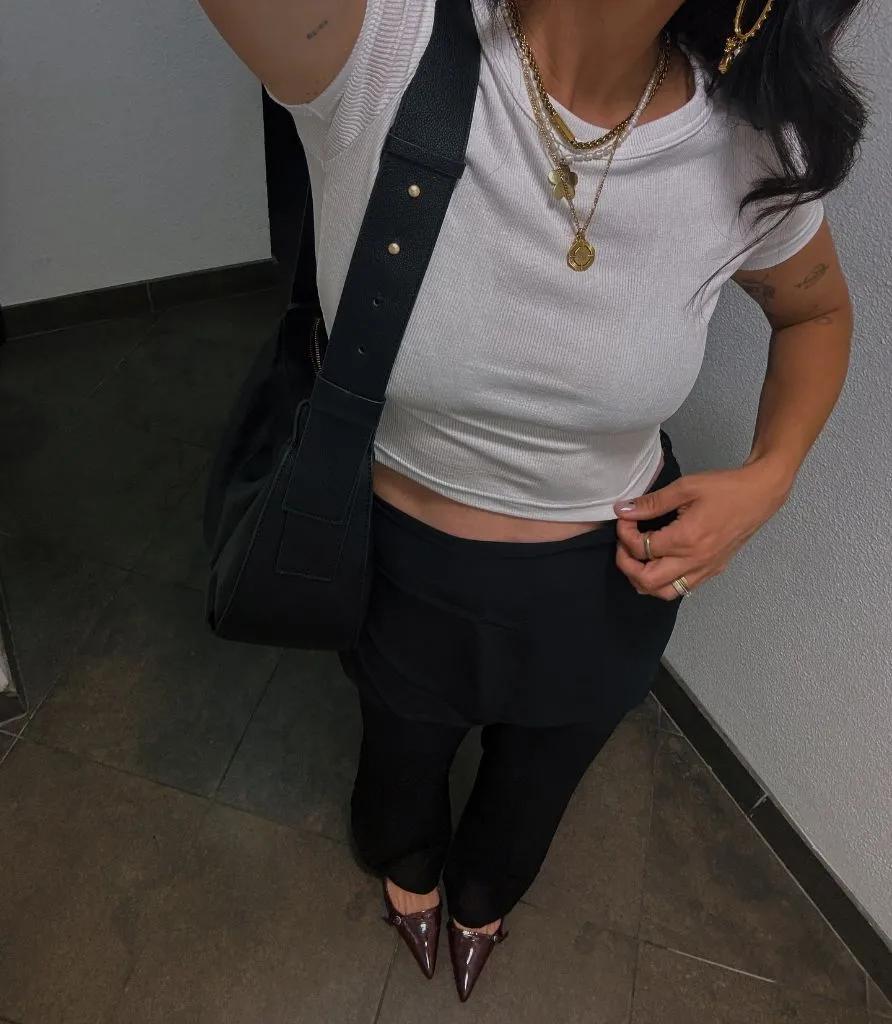 Fall professional outfit white baby tee black mini skirt tights pointed mules layered necklaces