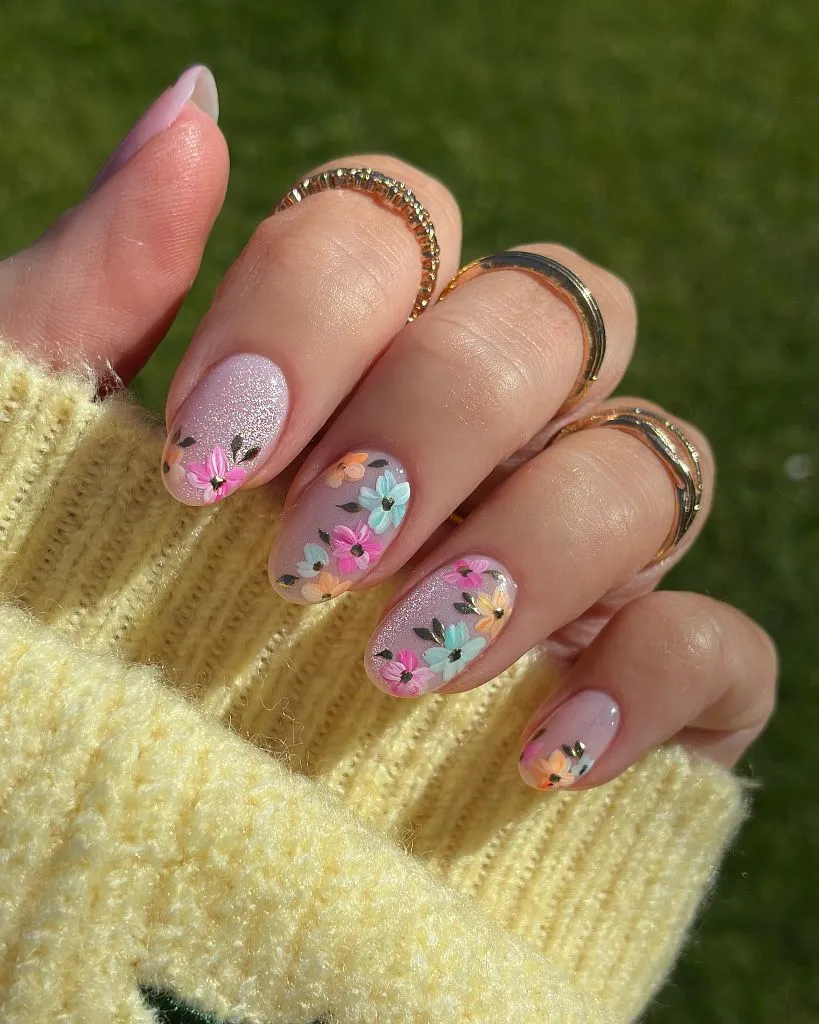 Colorful hand-painted floral nails on lilac shimmer base August nails color 2026 ideas