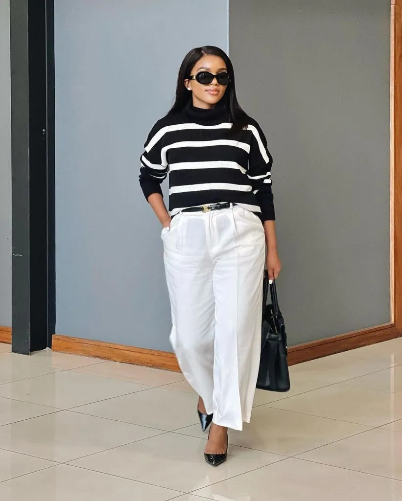Black and white striped turtleneck with white wide-leg trousers and black pumps