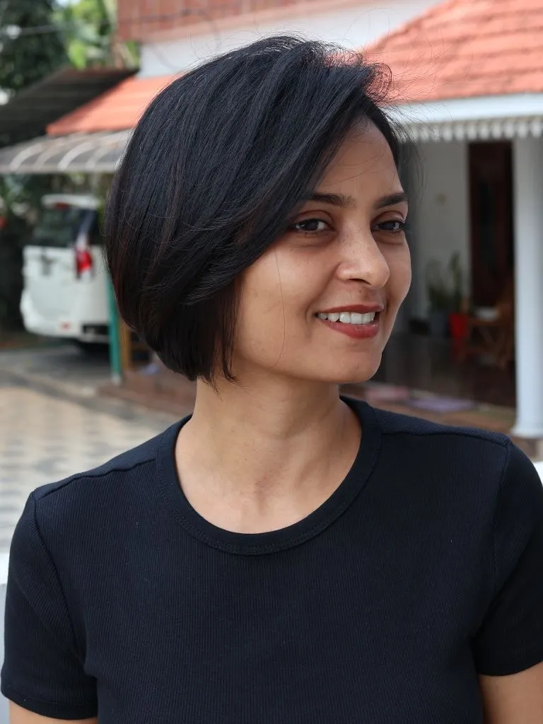 Fall Short Haircuts 2026 Jet Black Asymmetric Bob with Natural Side-Swept Volume