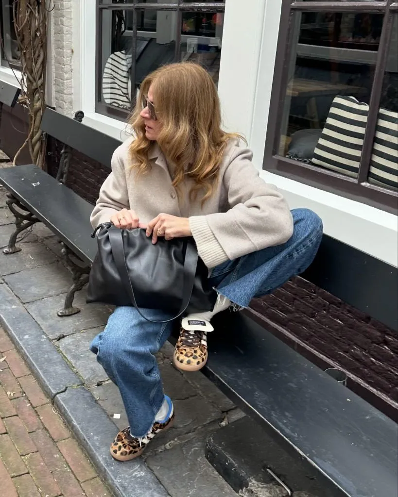 Beige wool jacket with relaxed jeans and leopard print sneakers