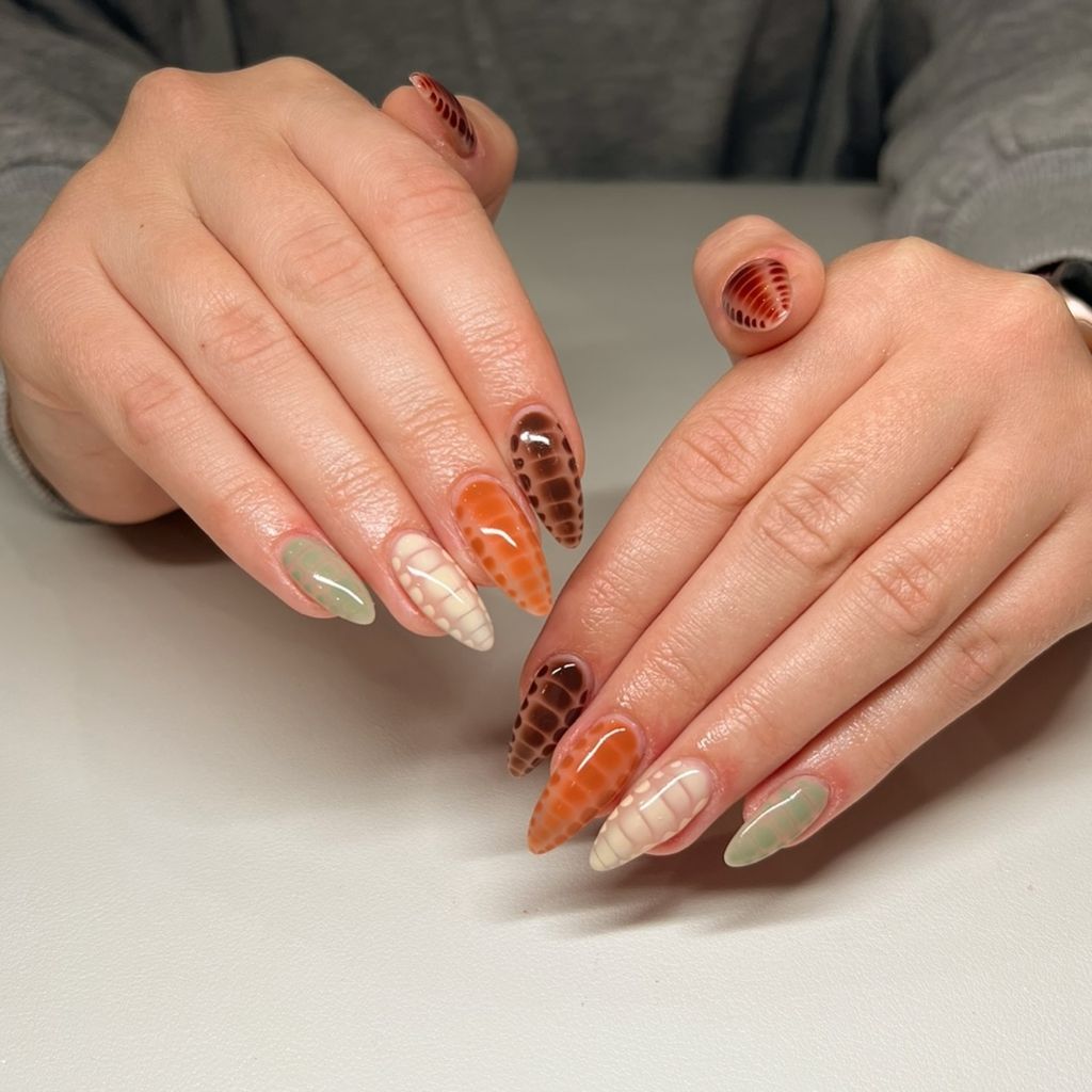 Reptile texture mixed almond nails in brown orange and sage green, unique August nails 2026