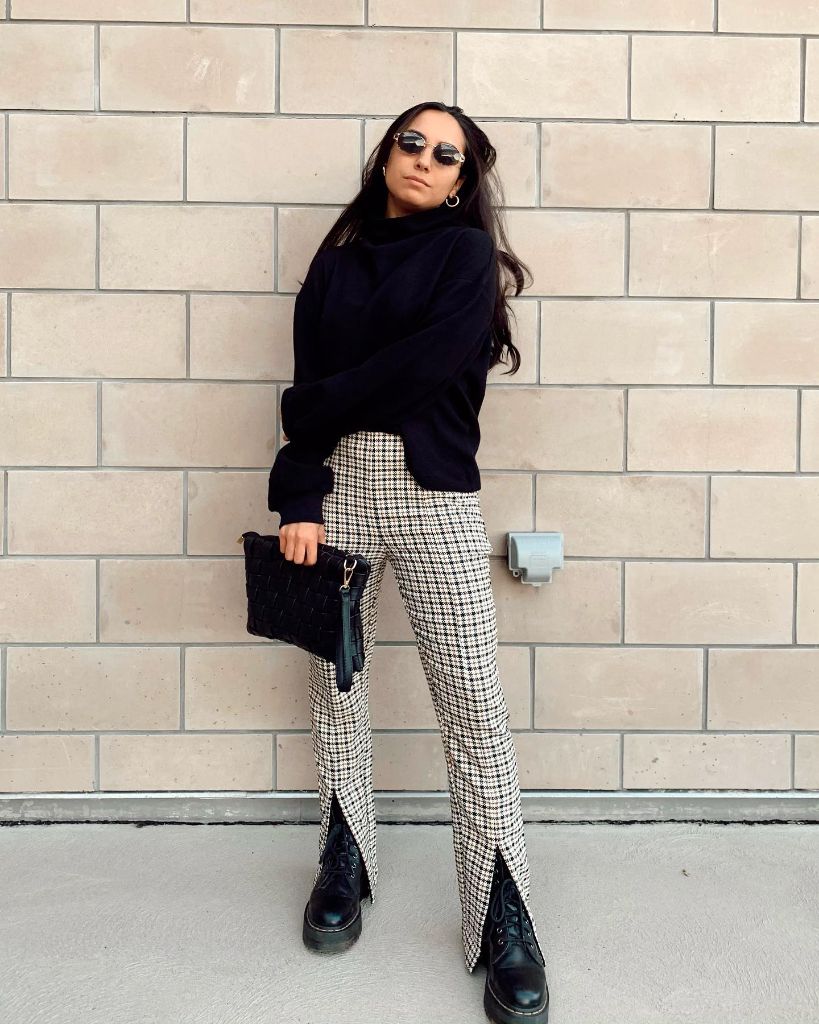 Black turtleneck sweater with houndstooth split-hem trousers and combat boots
