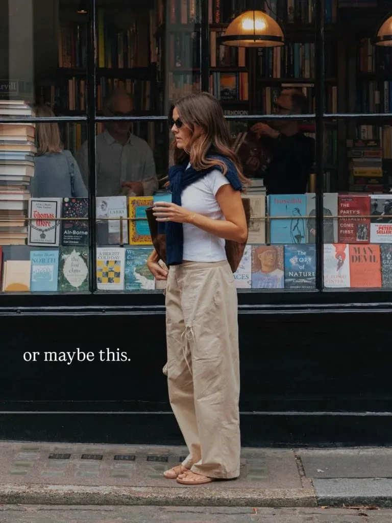 Casual summer-to-fall outfit with white tee and beige cargo trousers outside a bookshop